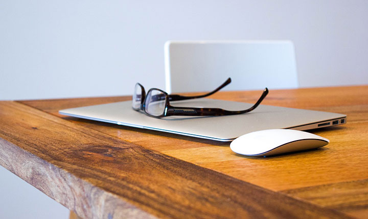 A pair of glasses sitting on top of a closed laptop. Simplicity in working_Equate_Feng_shui_NZ